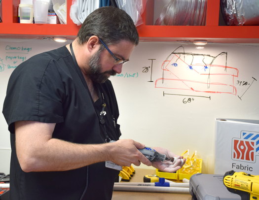 Jason Sheaffer works on a prototype of one of his ideas to improve nurse efficiency and patient care in the MakerHealth Space lab.