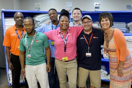 Glover with some of her colleagues in UTMB Laundry: (L-R) Reginald Thomas, J.J. Smith, Reggal Foreman, Glynnis Glover, Raymond Reyes, Junior Martinez and Debbie Incalcaterra.