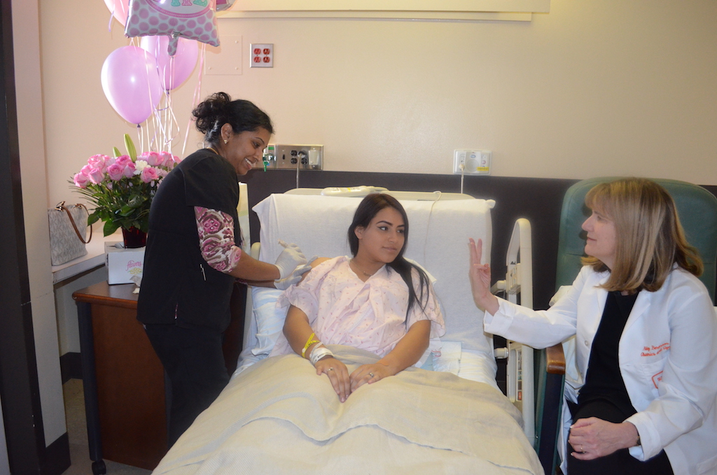 UTMB Nurse Latha Joy administers the HPV vaccine to patient Evelyn Perez while Dr. Abbey Berenson explains that a series of three injections is necessary for complete protection.