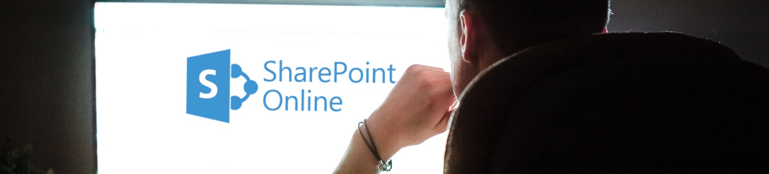 Man looking into large white monitor with SharePoint logo