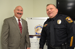 Galveston Police Chief Henry Porretto congratulates UTMB Police Chief Thomas E. Engells