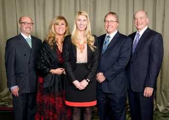 Dr. Tom Purgason, his wife, Michele Purgason and their daughter (standing between them), Ashley Purgason, are all UTMB alums. The Purgasons, along with other benefactors,  were honored during last year’s Sealy Society dinner. 