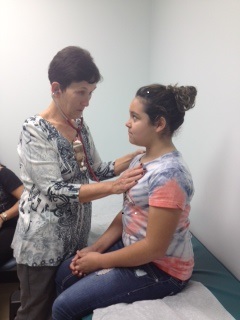UTMB nurse practitioner Gwyn Rossi with 11-year-old patient Brianna Cuaron at the UTMB Alvin Clinic.