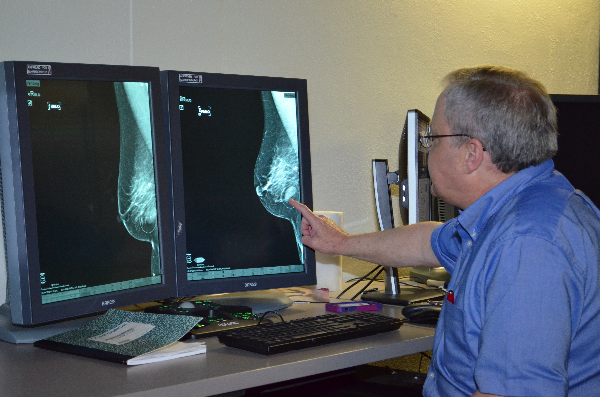 UTMB Director of Breast Imaging Dr. Morton Leonard points to a suspicious mass in a breast mammogram image. .