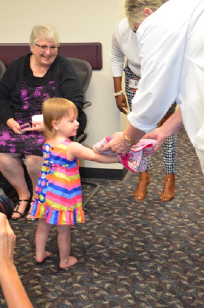 Annabelle hands over her blanket to Dr. Richardson