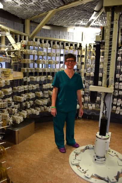 Shawn Carr stands inside the robotic prescription dispensing system in Central Pharmacy, which dispenses thousands of doses each day.