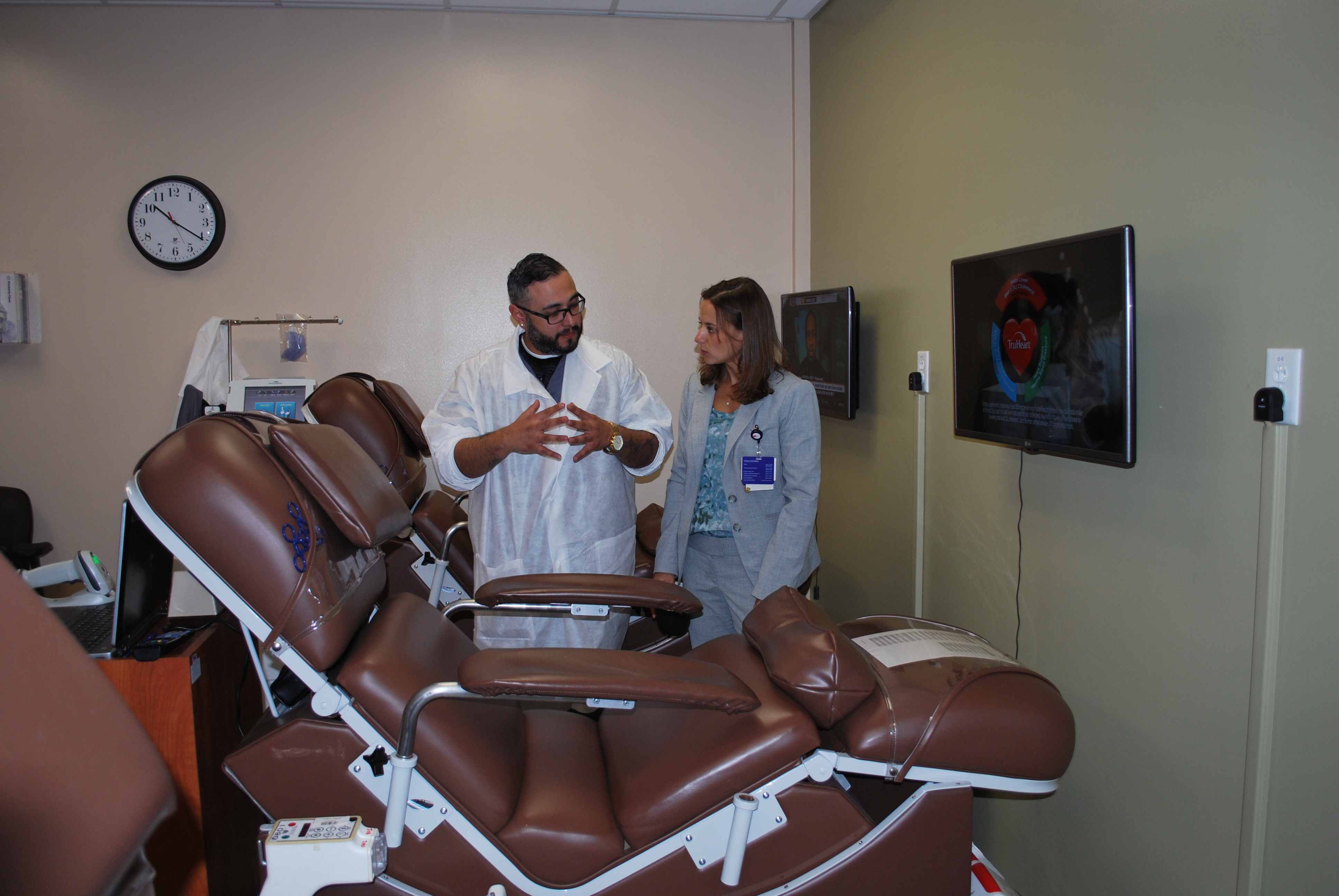 Lab Assistant Ramiro Valenzuela shows Emily Blomberg the new donor center