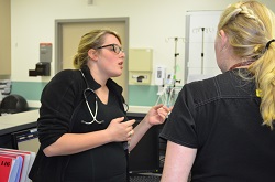 Ferguson discussing patient's care with fellow ER nurse 