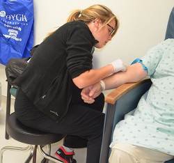 Ferguson drawing patient's blood