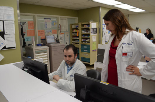 Care team members Dr. Sonstein and Dr. Solvik review patient's care plan