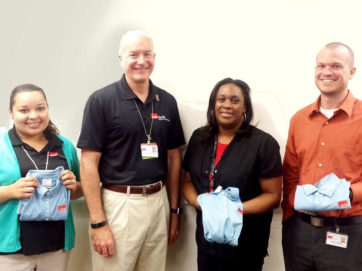 Laura Orellana, patient access specialist; Gail Farr, nurse clinician in Access Center; and Darwin VanDyke, associate director of Information Services, with Dr. Callender.