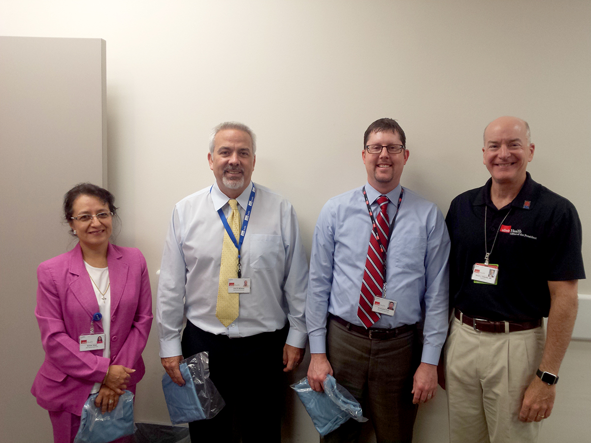 Norma Dryer, purchasing manager; Eric Williams, purchasing director; and Chris Gross, purchasing manager, with Dr. Callender.