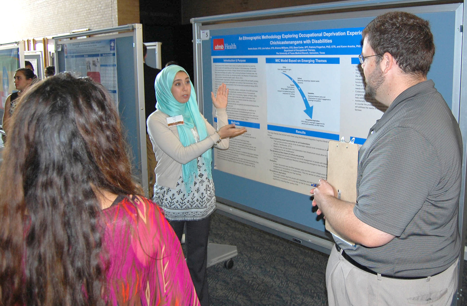 Lina Asfoor, graduate student in Occupational Therapy at UTMB, describes her team’s poster to a judge during the fourth annual Global Health Education Symposium. The team’s poster topic was “An Ethnographic Methodology Exploring Occupational Deprivation Experienced by Chichicastenangans with Disabilities.”