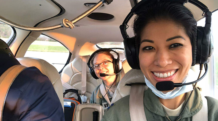 Selfie of two female pilots in small aircraft.