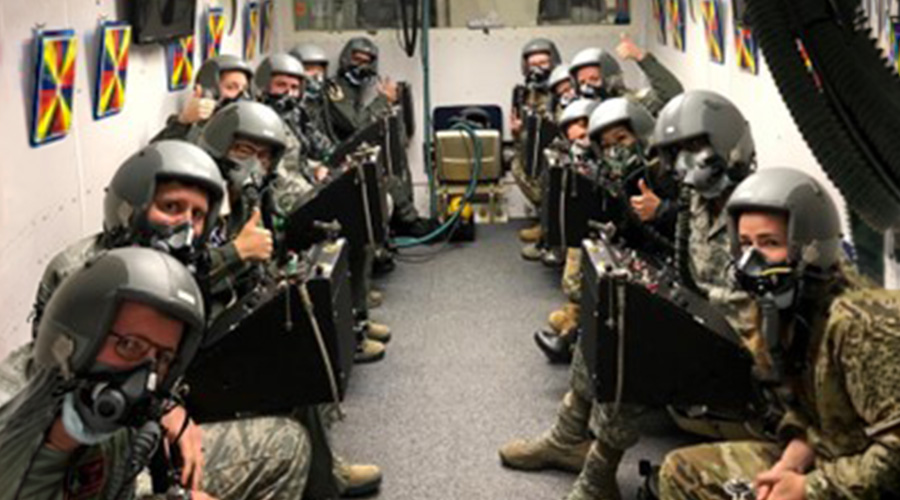 UTMB Aerospace & Exploration Medicine residents wearing aviation gear in hypobaric chamber.