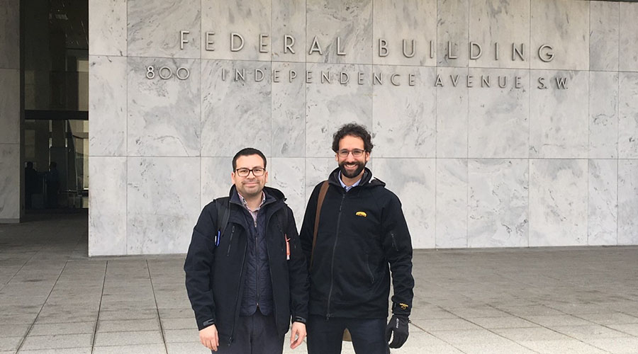 Two UTMB Aerospace & Exploration Medicine residents standing in front of Federal Aviation Administration headquarters building