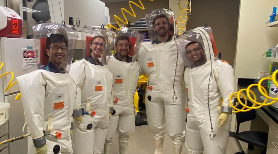 Five UTMB Aerospace & Exploration Medicine residents in inflated biohazard suits with attached air supply, as part of a hands-on tour.