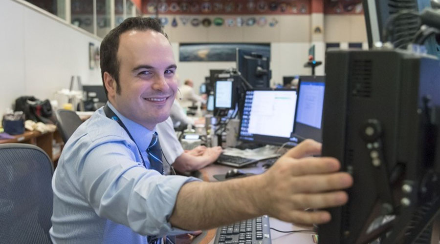 UTMB Aerospace & Exploration Medicine resident seated in front of computers and displays at the International Space Station “Surgeon” console.