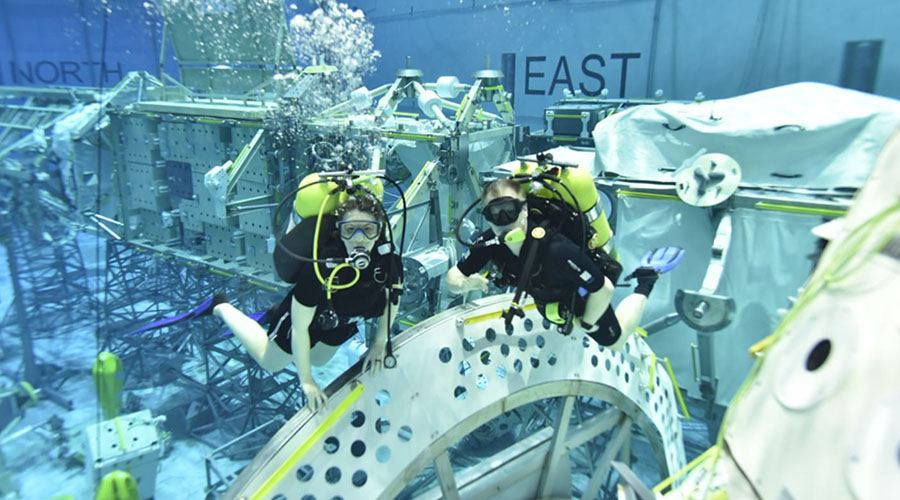 Dr. Amy Kreykes and fellow professor in UTMB Aerospace & Exploration Medicine neutral buoyancy lab.