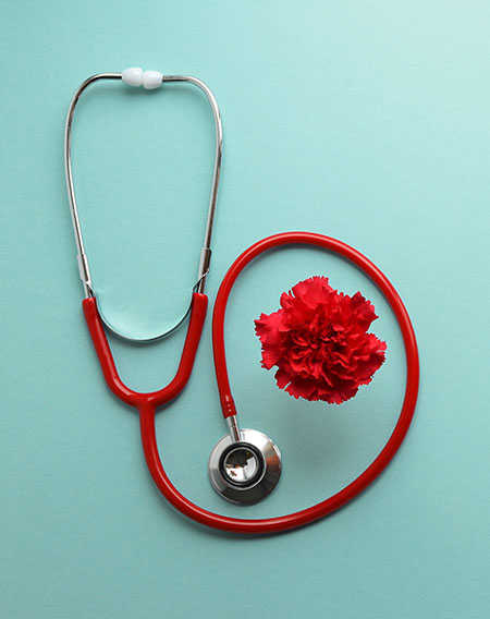 Stethoscope and red carnation