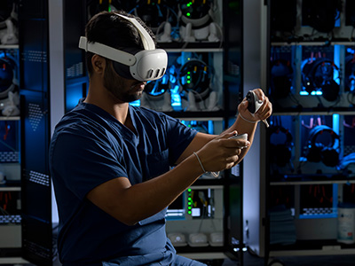 Man using a virtual reality headset and controllers in a technology lab