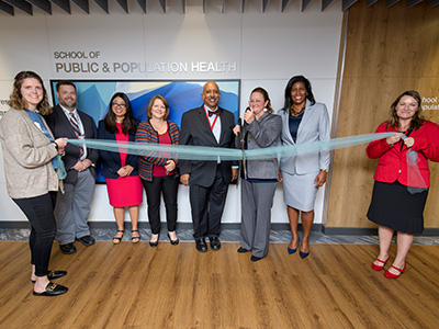 UTMB faculty and staff cutting ribbon at School of Public & Population Health (SPPH).