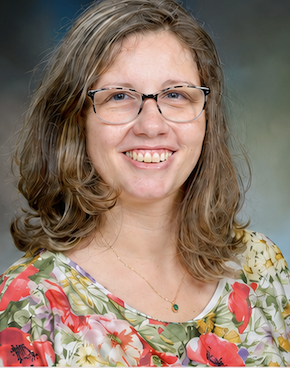 woman wearing glasses, smiling