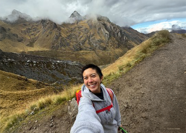 Student standing in front of mountains in Cusco, Peru