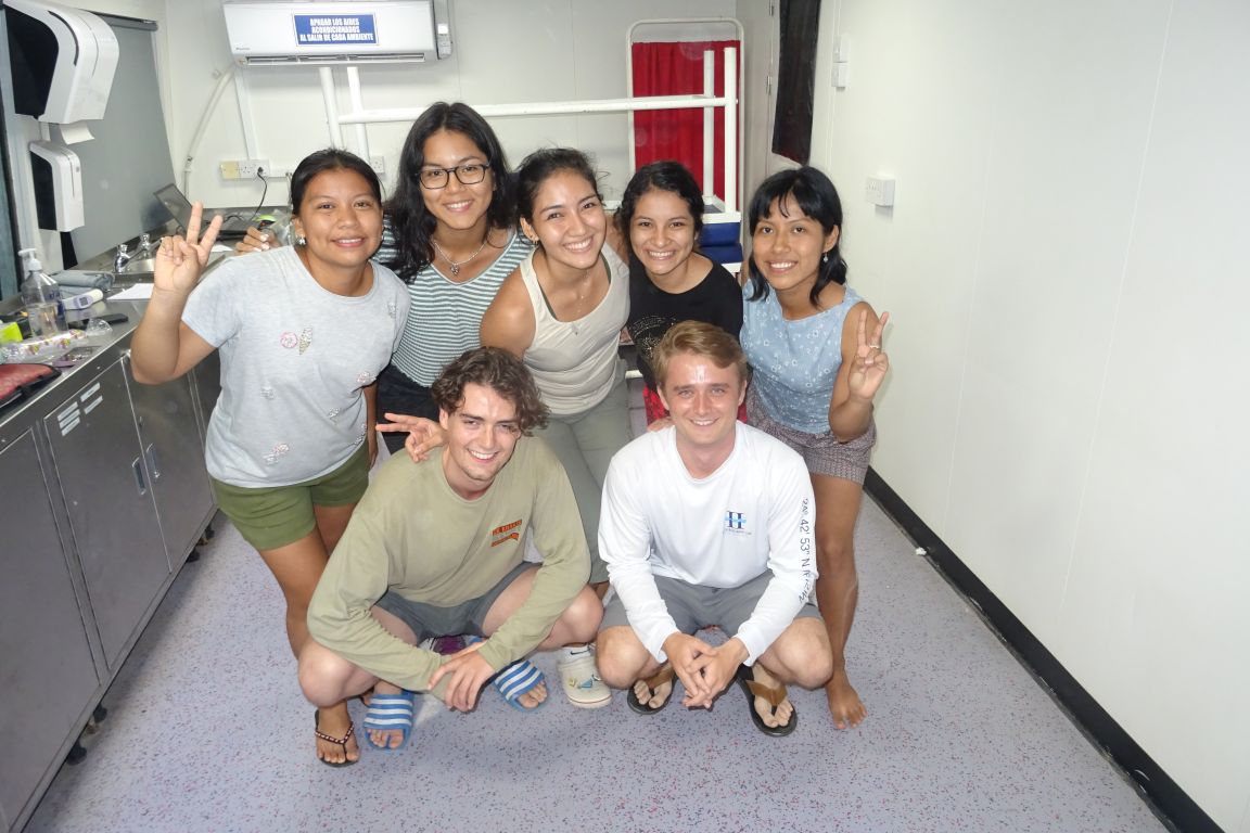 Group of seven students posing in medical clinic.