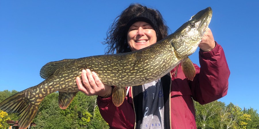 Photo of woman holding a large fish