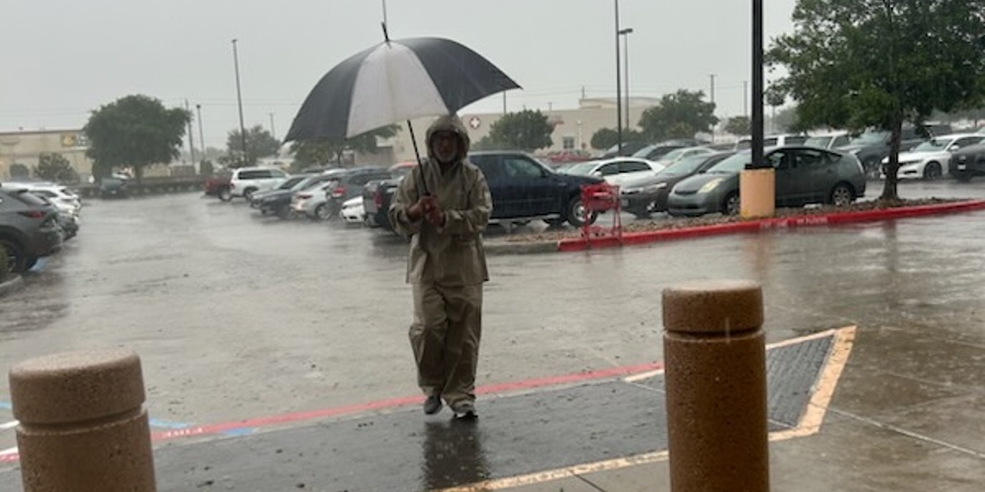Photo of man walking in the rain