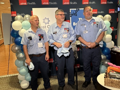 bc4 Imge of three men standing by balloons