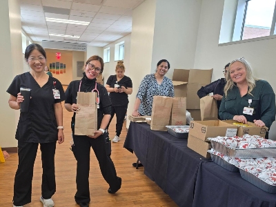 Image of women in scrubs with lunch bags