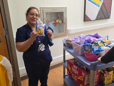 Image of woman in scrubs with snacks