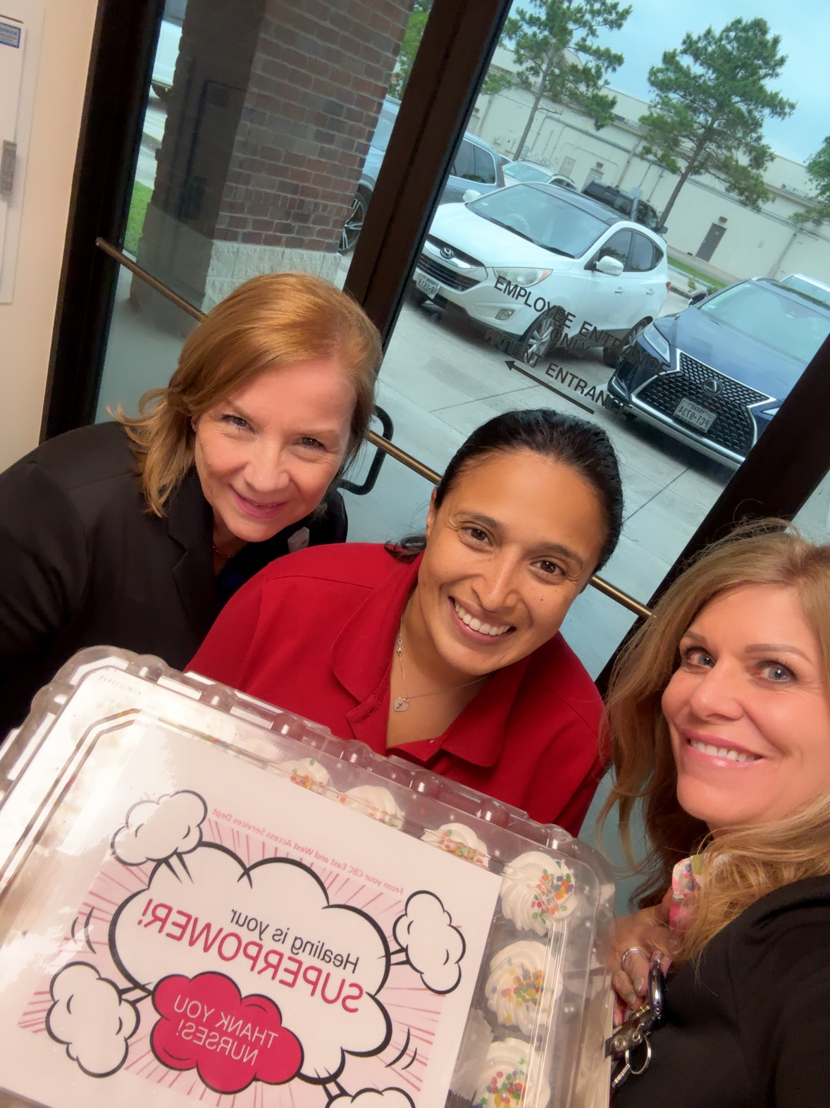 Image of three women with a cake