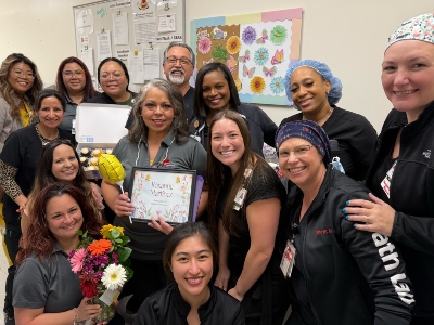 nurse 4 Image of a group of nurses, one in the center with certificate