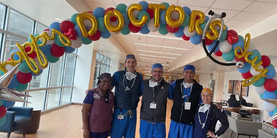 Group photo of doctors under balloon arch