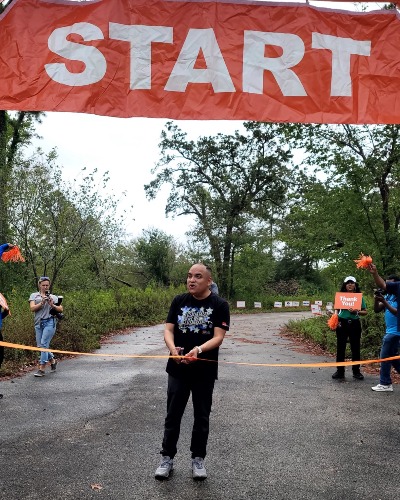 Image of man cutting a ribbon