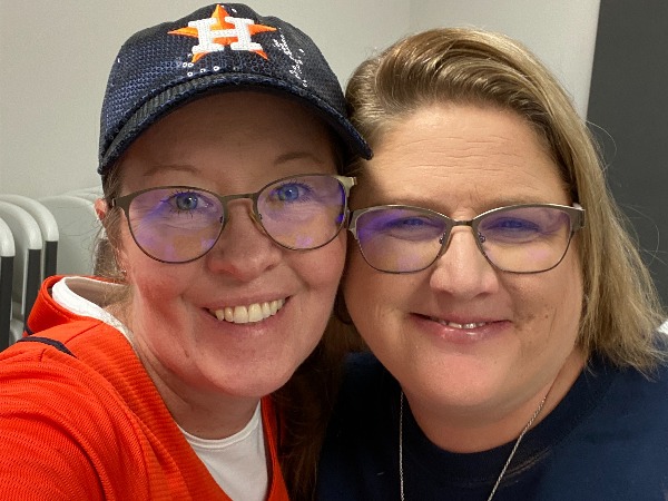 Two women, one with Astros hat