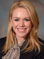Professional headshot of smiling woman with blond hair