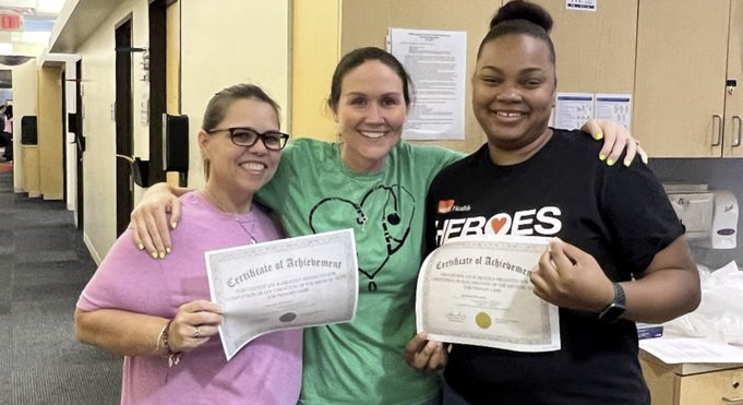 Dr. Stephanie Herrera, center, celebrates with Jennifer Eernisse, left, and Jazmine Edwards as they receive their certificates of completion.