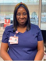 Dark skinned woman in blue scrubs