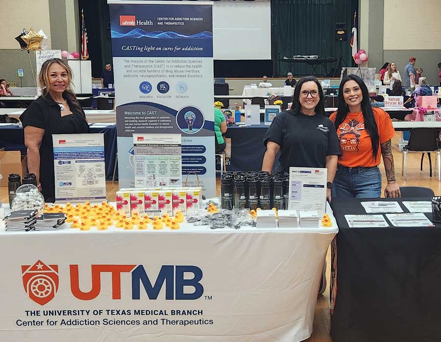 women at a conference booth