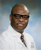 Professional headshot of Dr. Olugbenga Ojo wearing a white medical lab coat, striped tie, and glasses against a blue‑gray gradient background.