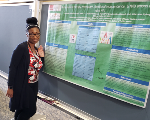 Dr. Amber Armstead stands in front of her poster presentation