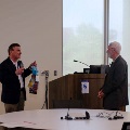 Dr. Reistetter giving Dr. Ottenbacher a gift