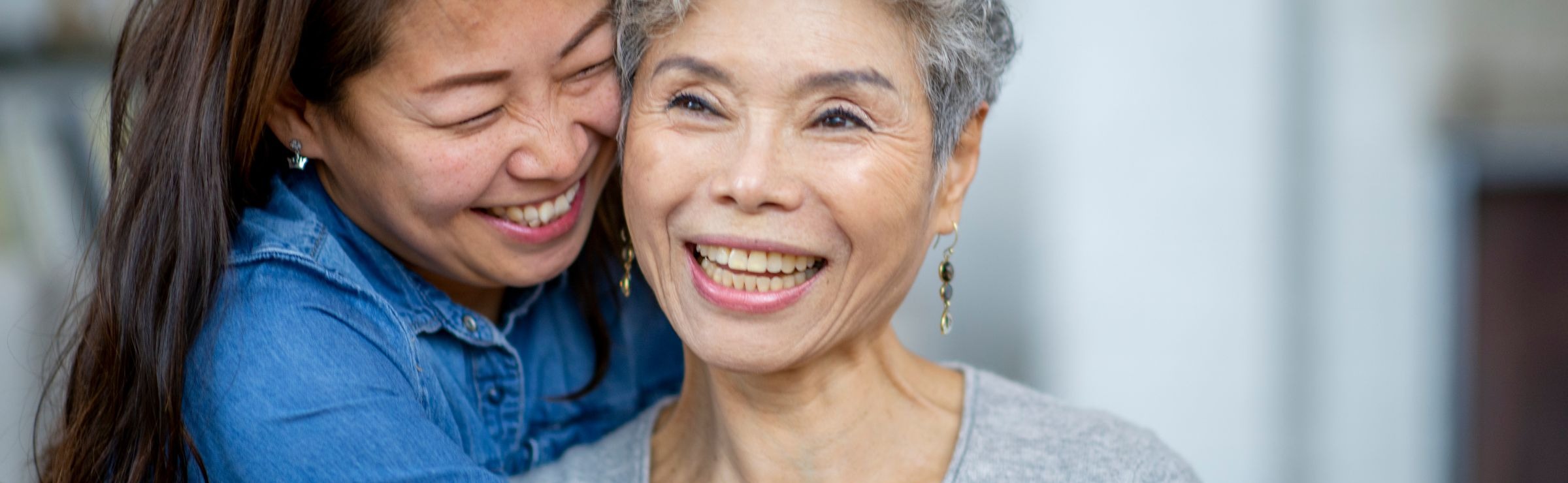 photo of younger woman embracing an older woman