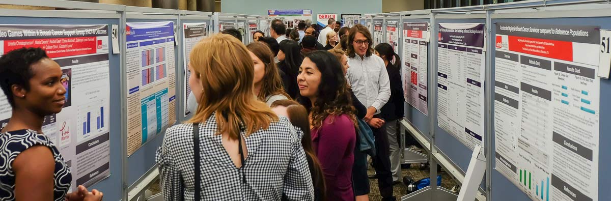 Photo of several people attending a research poster session