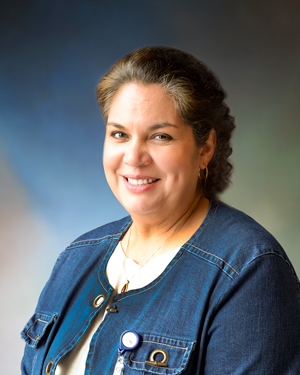 a woman smiling in a studio portrait setting
