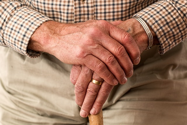 photo of older adult's hands holding a cane